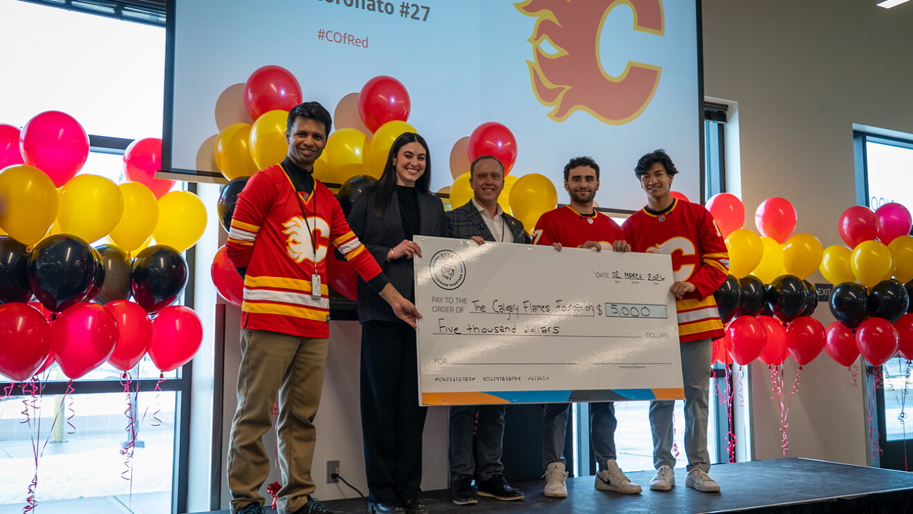 Two Calgary Flames hockey players packing and shipping Amazon boxes