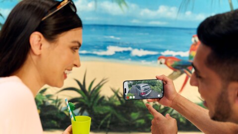 Couple watching their car on a phone screen