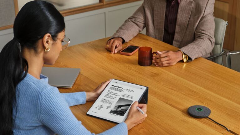 Business meeting with digital note-taking on tablet