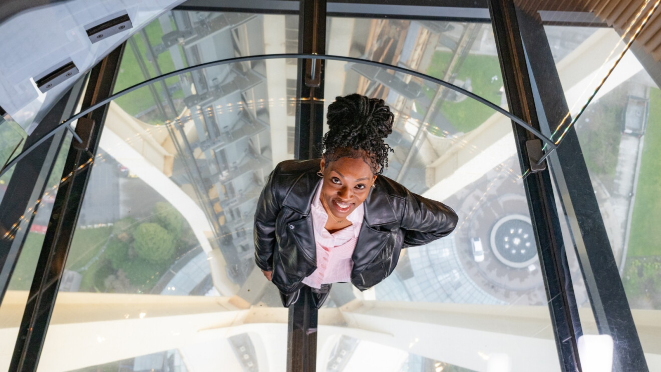Professional woman looking up with city view below
