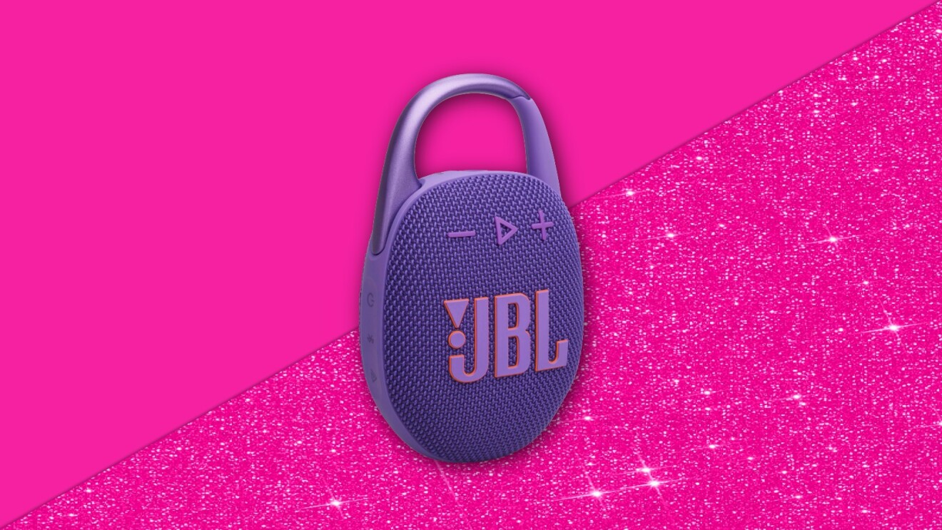 Purple JBL clip-on speaker against vibrant pink glittery background