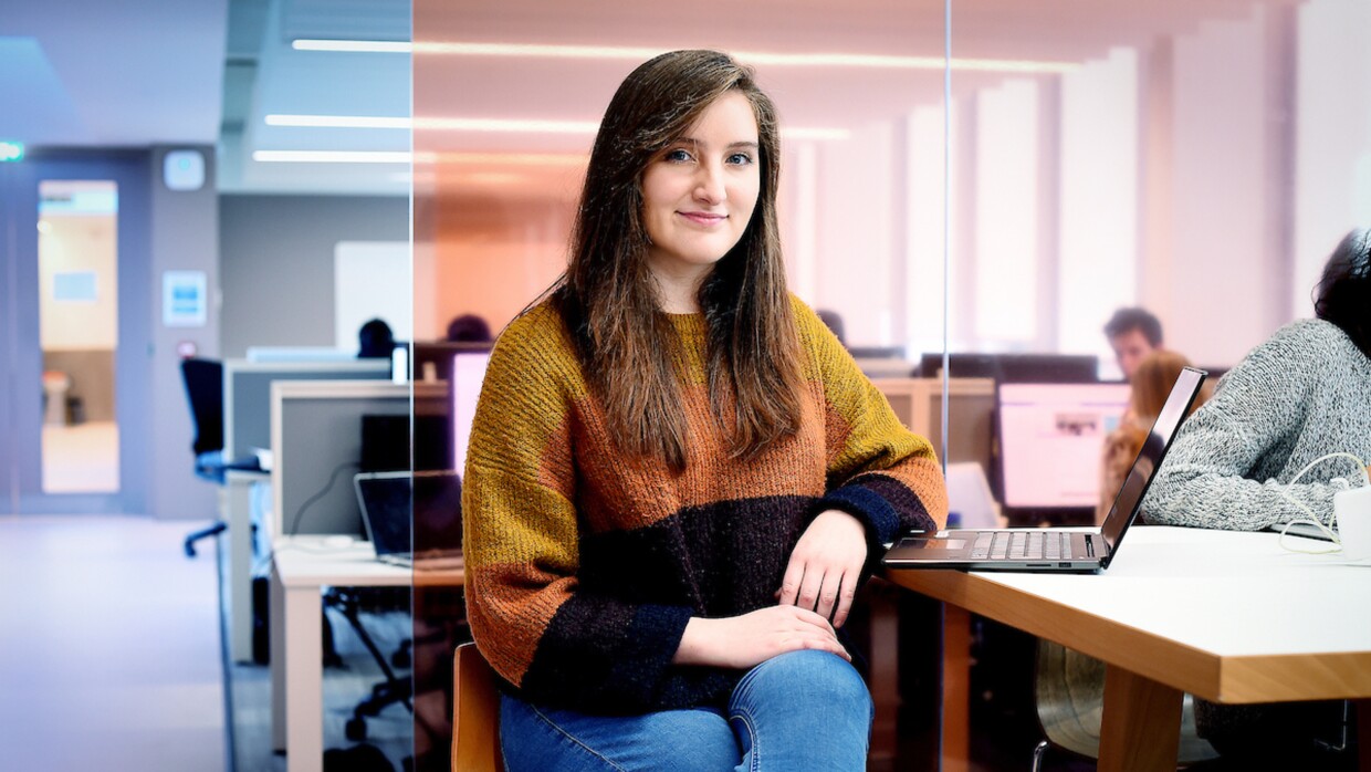 Robyn Greene an AFE Bursary awardee sitting at a table with a laptop next to her.