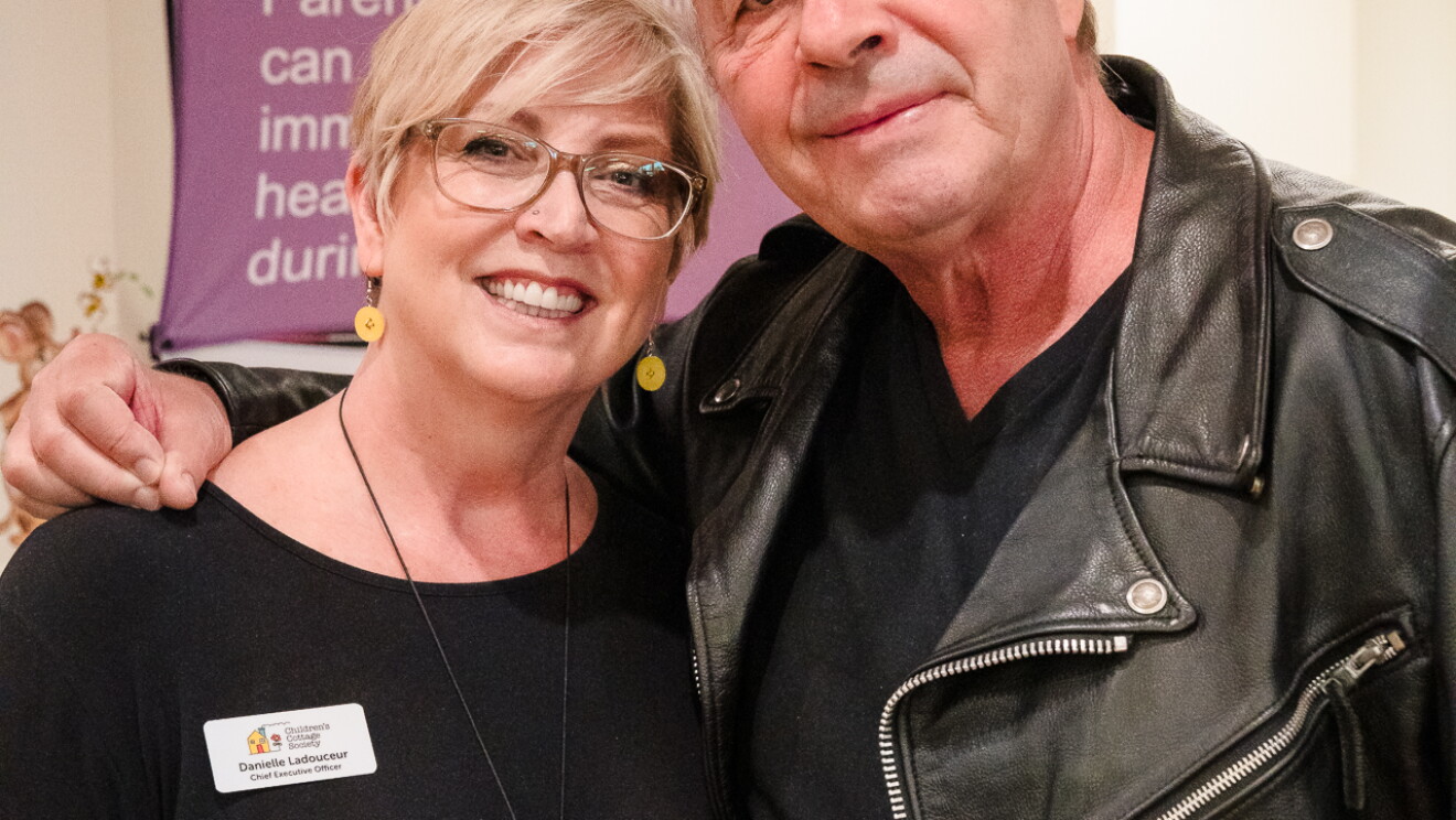 Bret "The Hitman" Hart posing with Children's Cottage Society CEO.