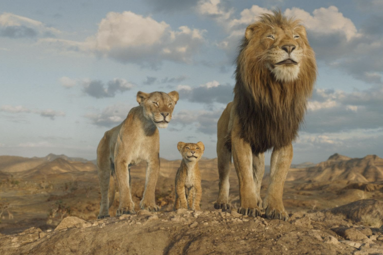 A still from showing two lions and a cub from Mufasa: The Lion King