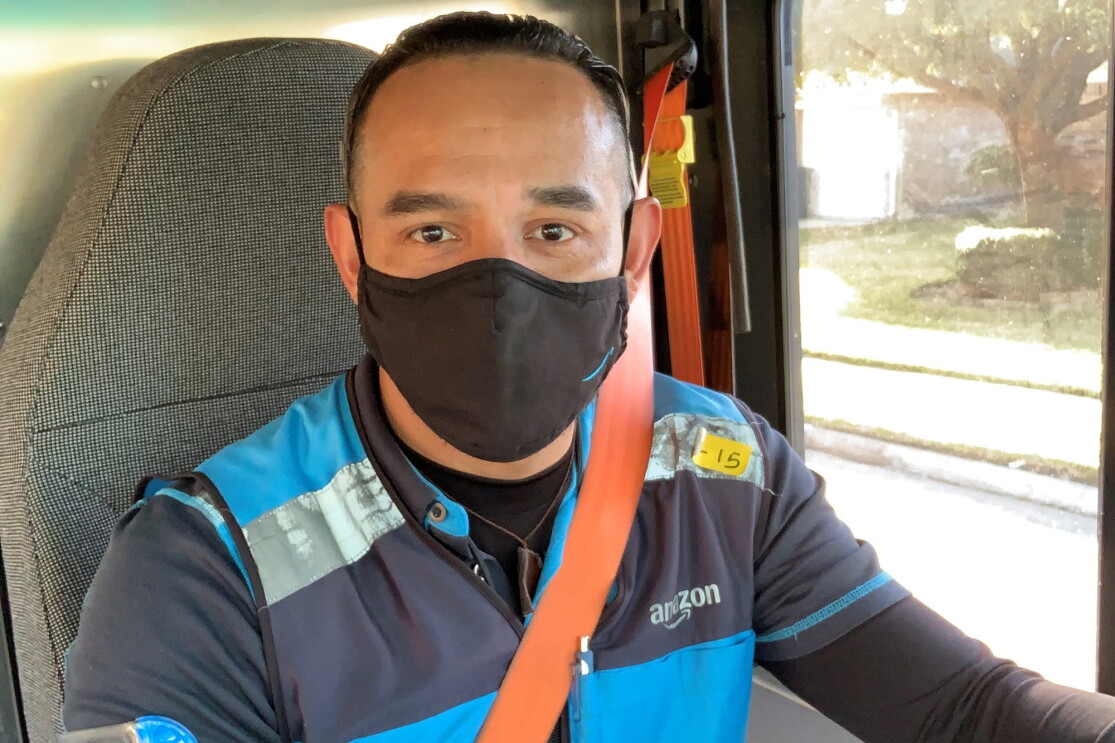 Amazon Delivery Service Provider (DSP) in their work vehicle, wearing an Amazon vest
