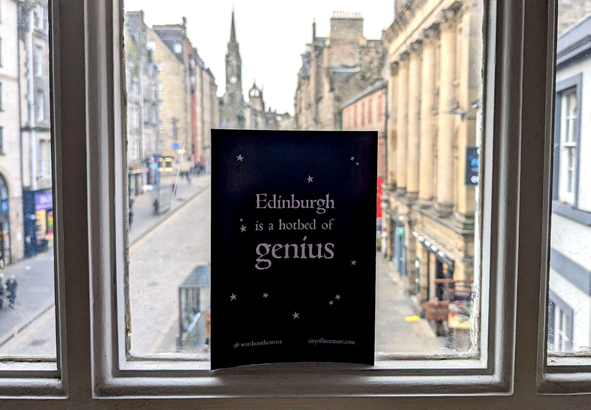 An image of a sign in an Edinburgh window which says 'Edinburgh is a hotbed of genius'