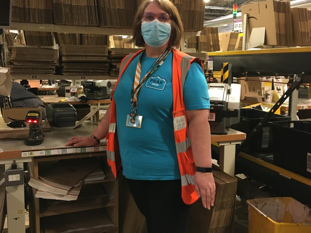 Donna McLaughlan, FC Associate, standing at her desk in the fulfilment centre.