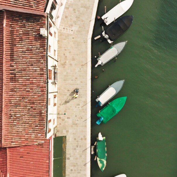 Photos of an aerial view of the Lagoon and an Amazon delivery driver handing over a delivery to a customer at his doorstep.