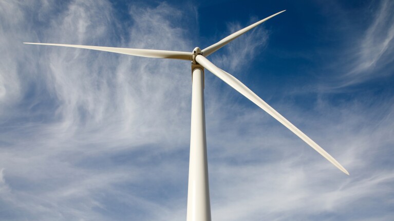 Wind turbine against a blue sky backdrop