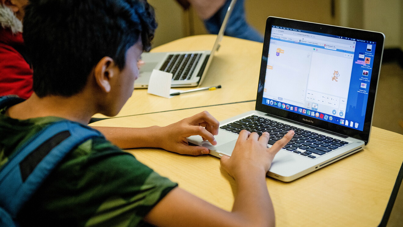 Students at a NYC high school, working on laptop computers as they learn to code as part of the Amazon Future Engineer program.
