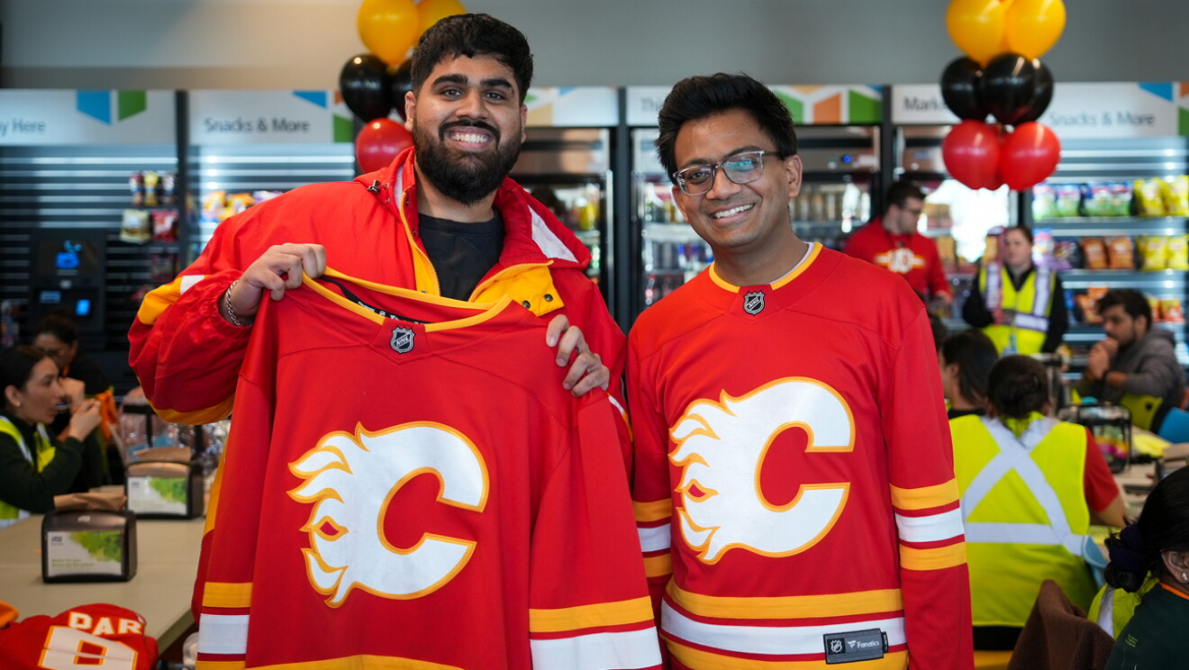 Two Calgary Flames hockey players packing and shipping Amazon boxes