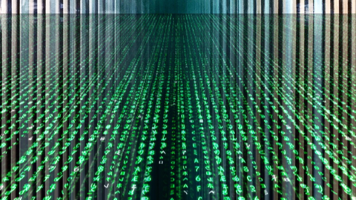 An abstract image of computer code on a screen. It's largely colored green. 