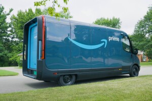 An Amazon Rivian delivery vehicle is parked outside on a residential street.