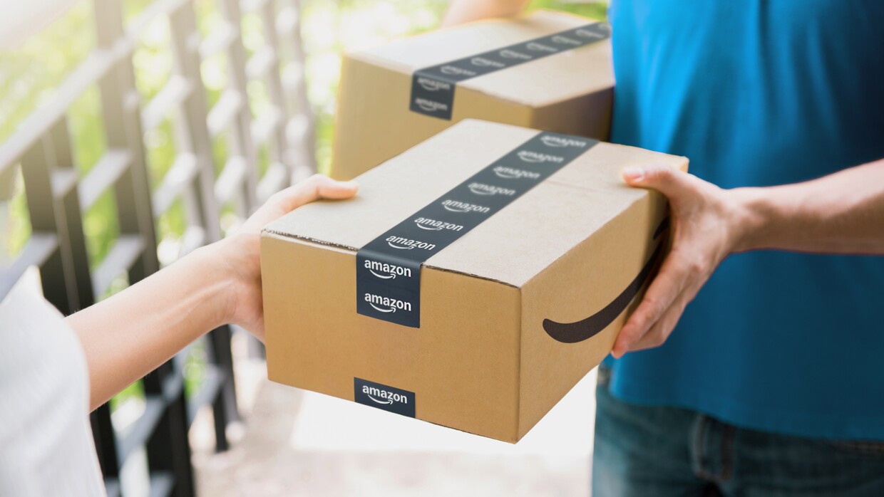 An image of someone handing over an Amazon package to someone else