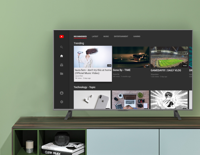 A television sits on a console table, with the television screen displaying the YouTube experience on Fire TV.