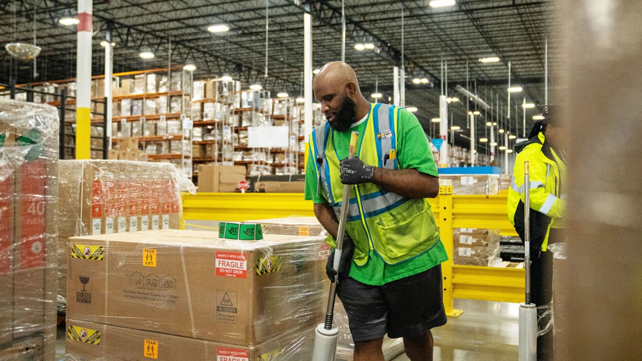 Amazon employee works in a fulfillment center.