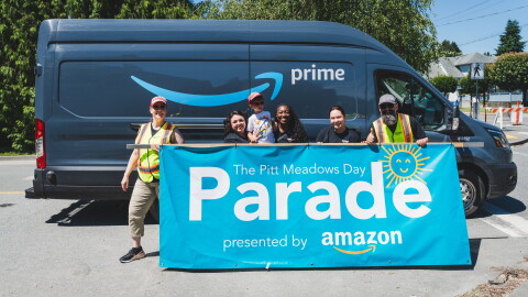amazon employees standing in front of a truck