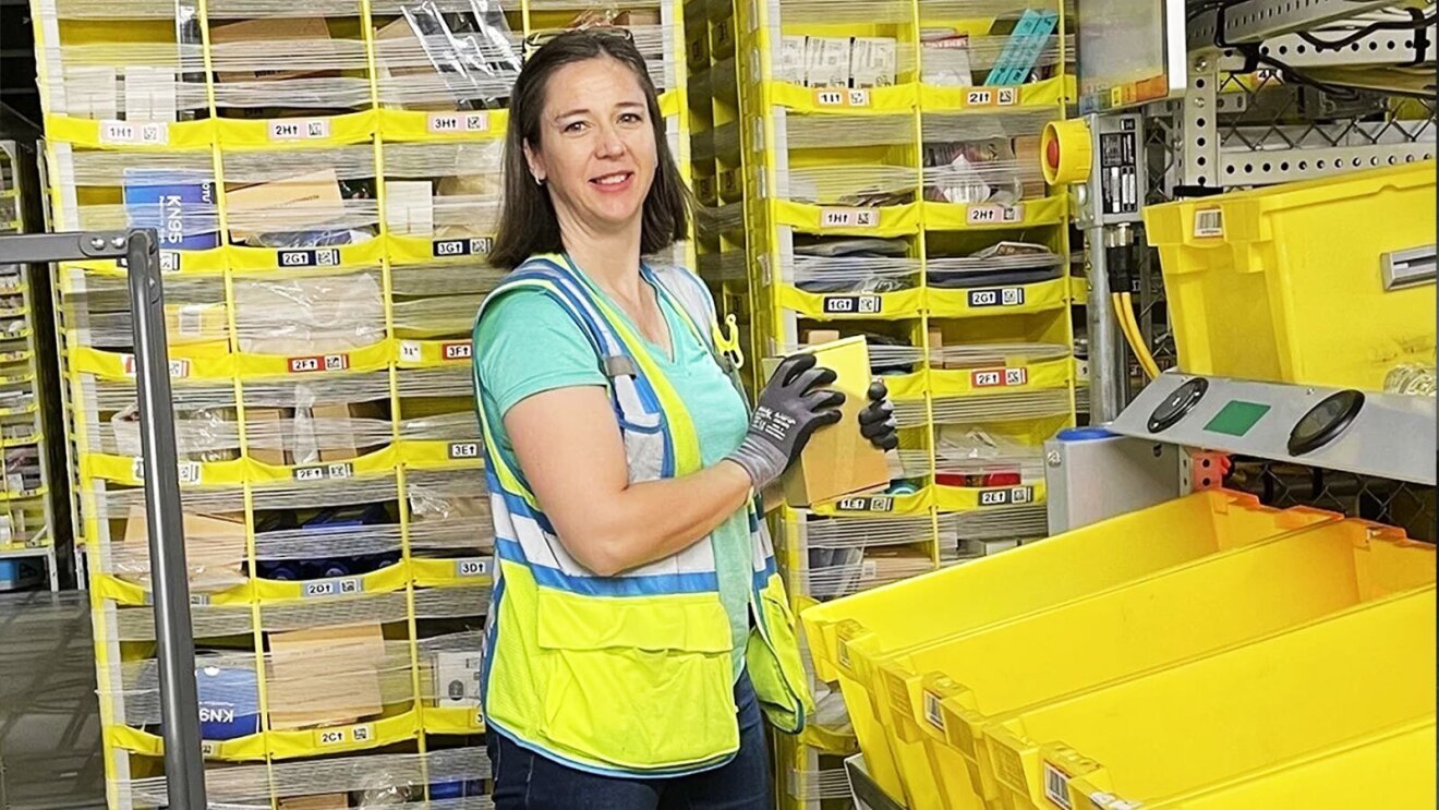 Catherine Lemonds smiles as she works in a fulfillment center.