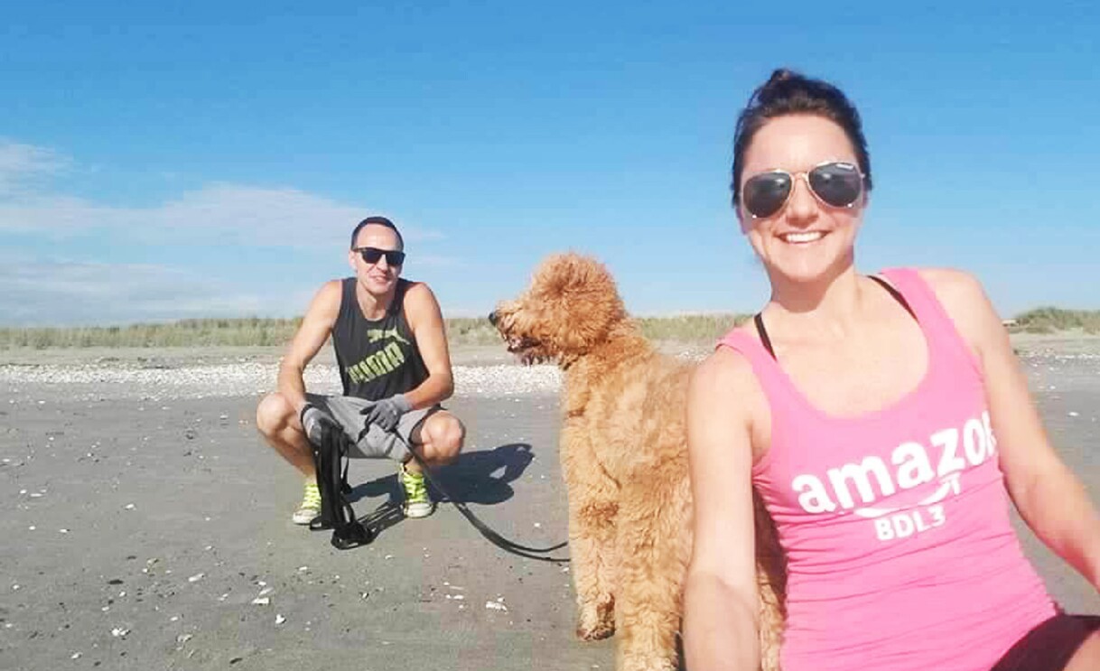 A gallery of images of Amber. First image, Amber works in a fulfillment center and wears a yellow safety vest, second image, Amber poses with her dog and friend, third image, Amber is dressed up for a wedding and looks and smiles at her date who is in a tux.