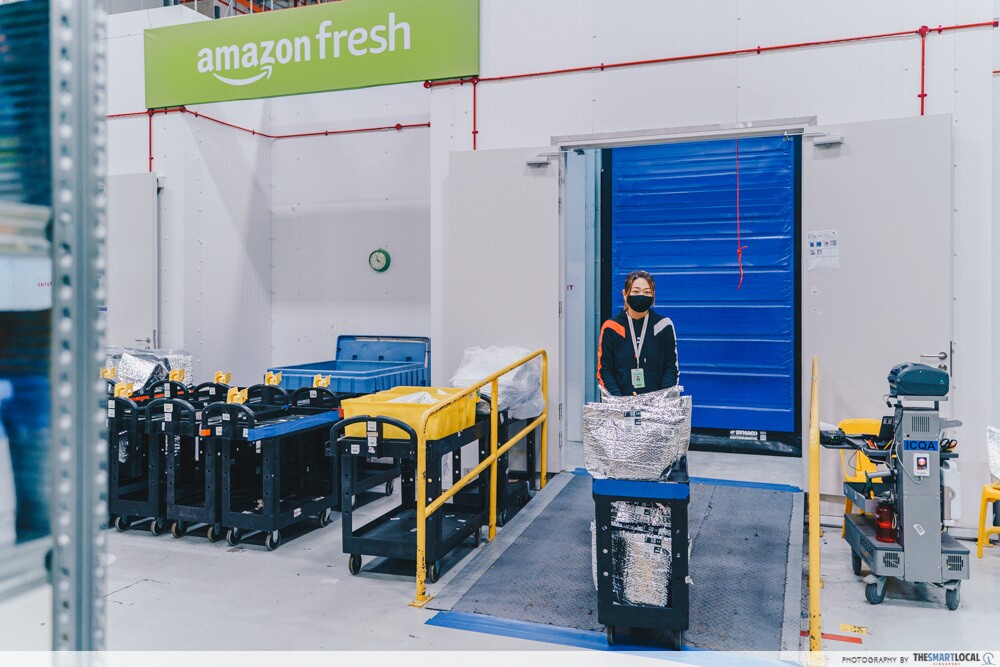 An employee pushing a trolley out of the chiller and freezer