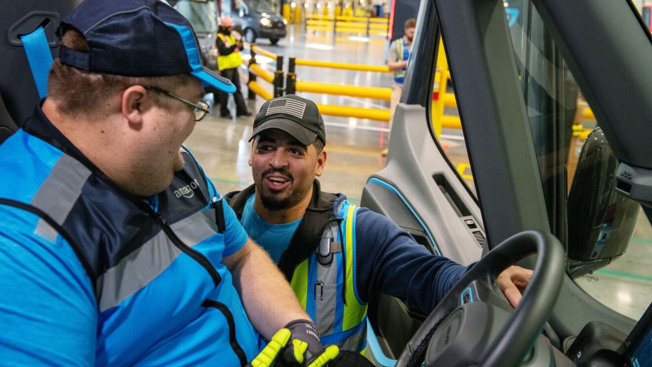 Delivery safety trainer shows a new driver how to use the electric delivery vehicles.