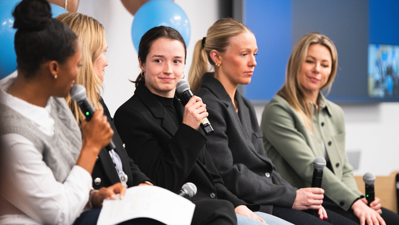 women speaking at event 