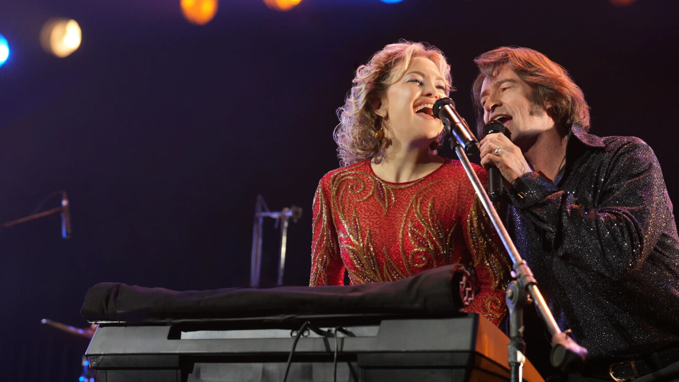 Man and woman singing on stage