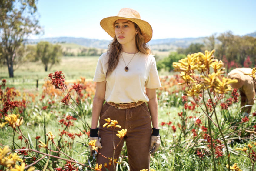 Alice standing in a flower field