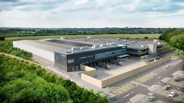 Aerial view of modern Amazon warehouse facility with solar panels on roof