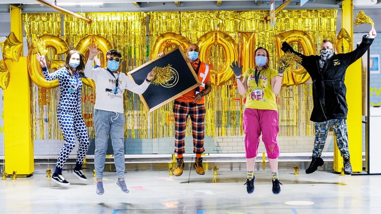 Amazon Goes Gold staff in front of gold 'go gold' banner
