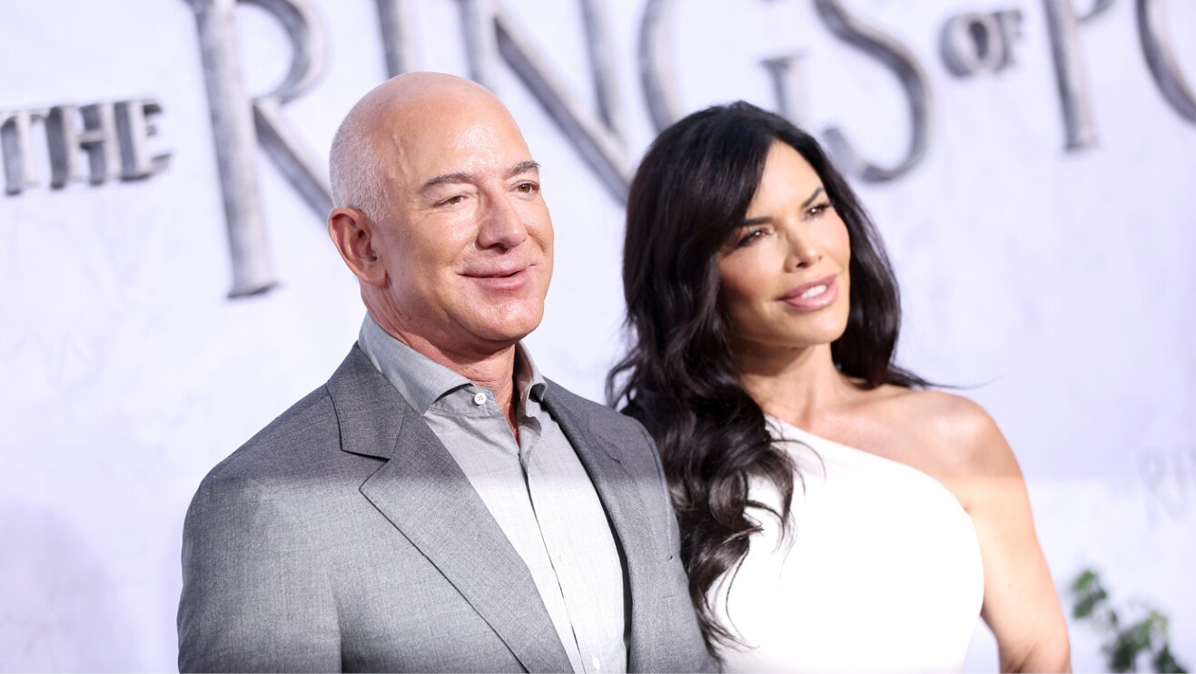 Jeff Bezos and Lauren Sanchez smile for a photo on the red carpet of the Lord of the Rings: The Rings of Power premiere.