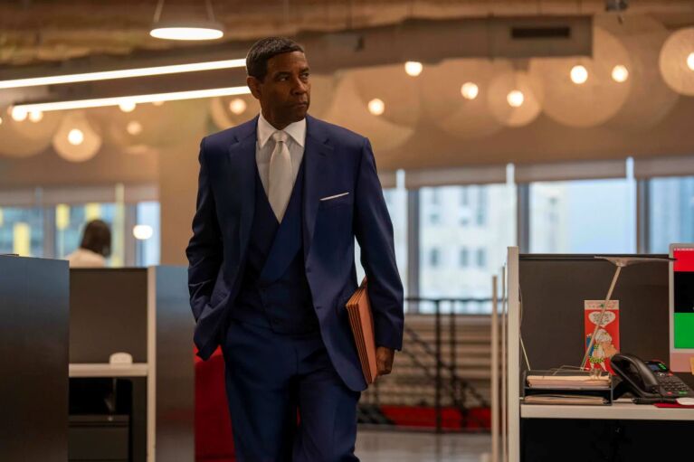 Denzel Washington dressed smartly as he walks through an office space