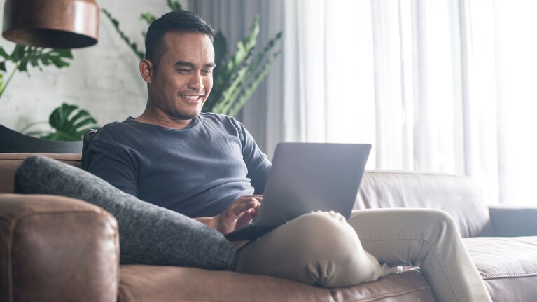 Man with laptop signing up for Amazon Prime.