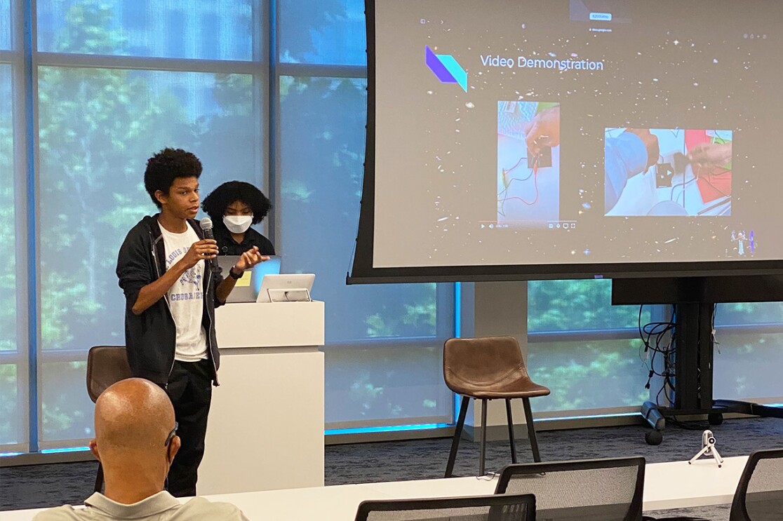 An image of an Amazon Greene Scholars participant giving a presentation.