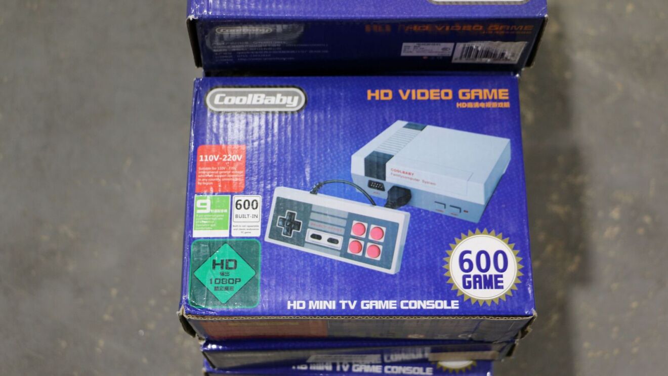 Stacked boxes of CoolBaby HD Video Game consoles with 600 built-in games