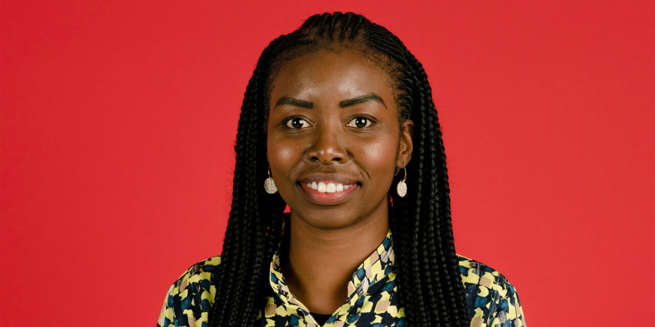Headshot of Ramat Tejani in front of a bright red background.