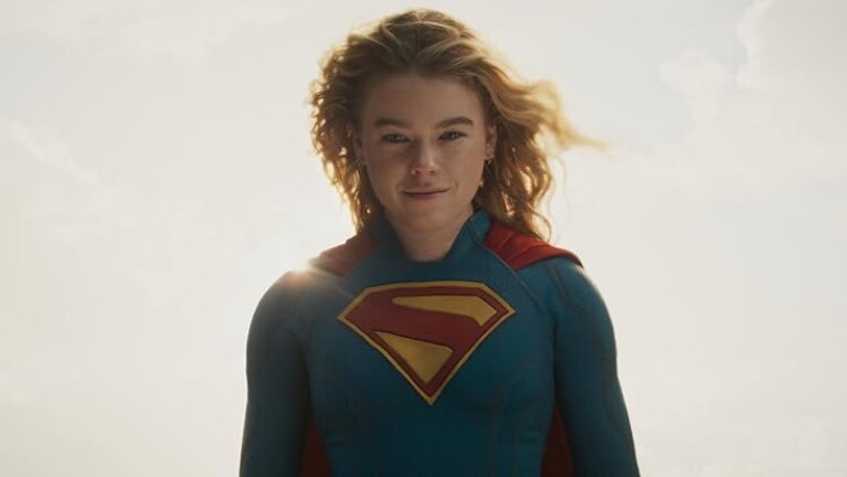 Headshot of a blonde woman smiling in her supergirl outfit