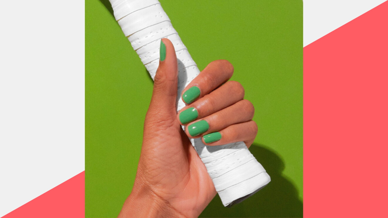 Prime Day 2023 live blog best deals: hand model wearing green nail polish while holding a white tennis racket.
