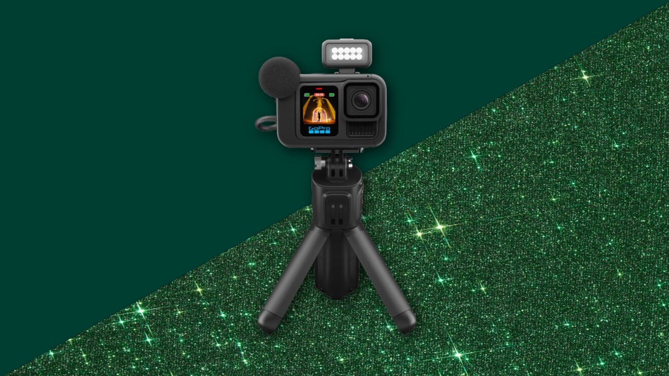 GoPro camera on tripod with LED light against sparkling green background