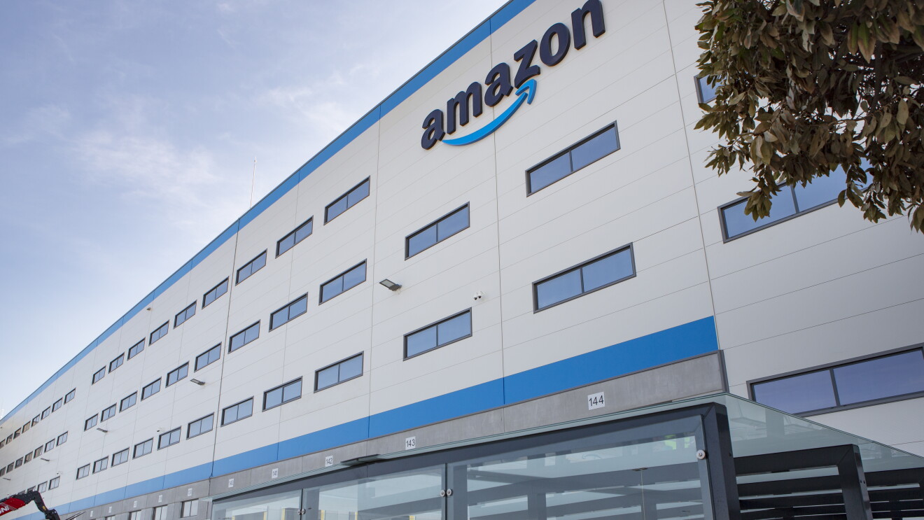 Photo of the Dos Hermanos fulfillment center in Spain, view of the building entrance with Amazon signage.