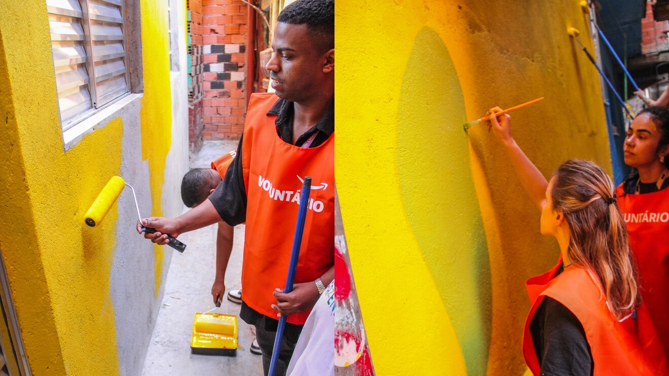 Volunteers in orange vests painting yellow walls in a community project in Brazil
