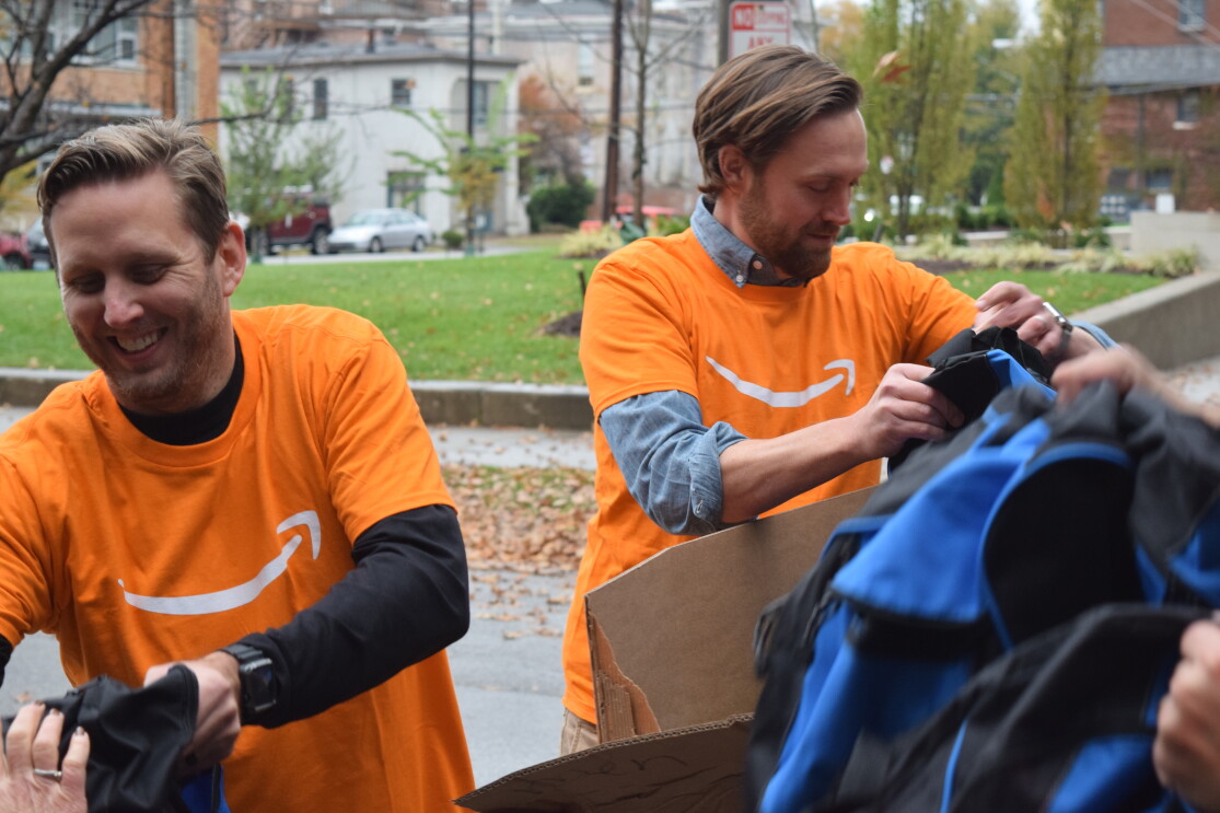Amazon associates unload backpacks full of essential supplies