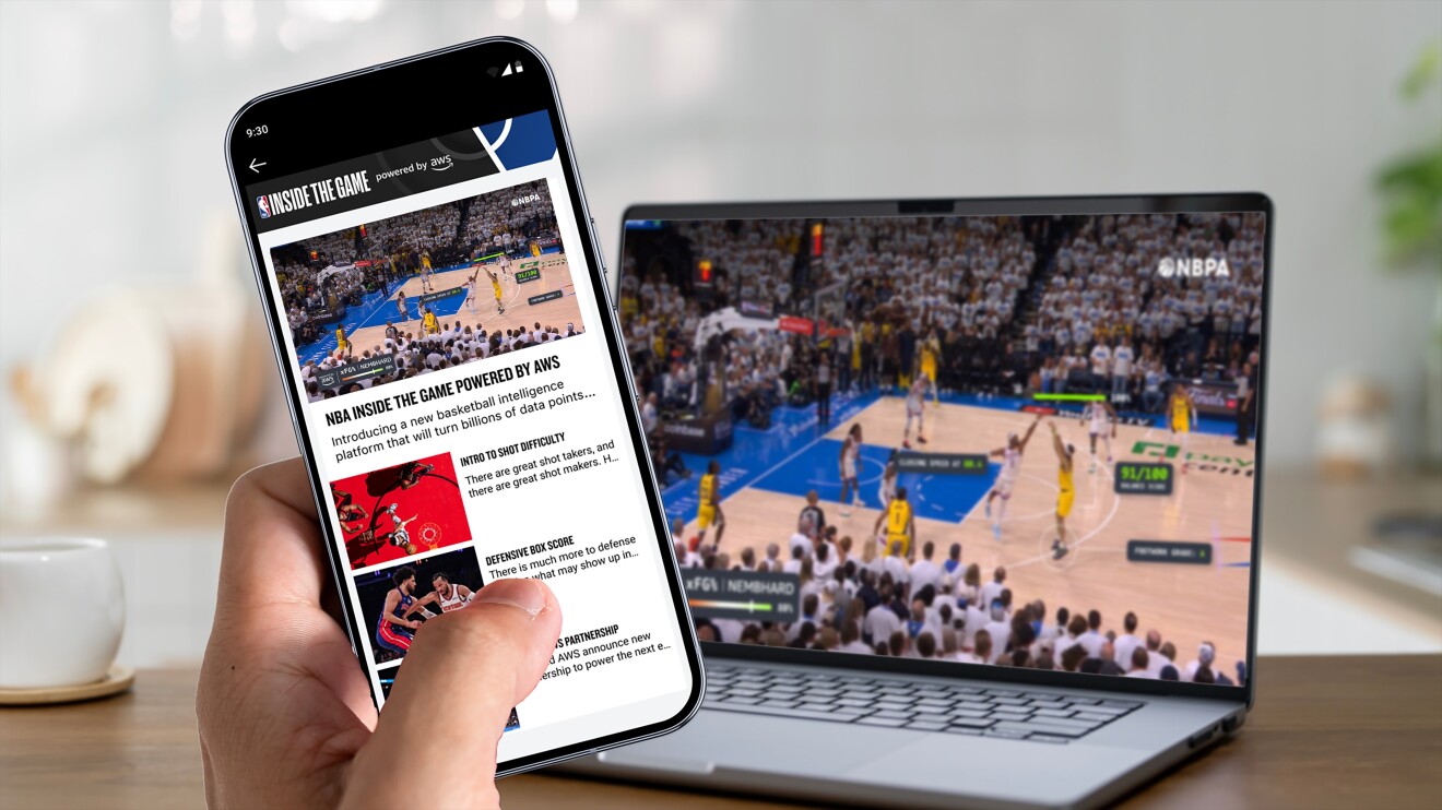 NBA Inside the Game app on smartphone next to laptop showing live basketball game using AWS insights