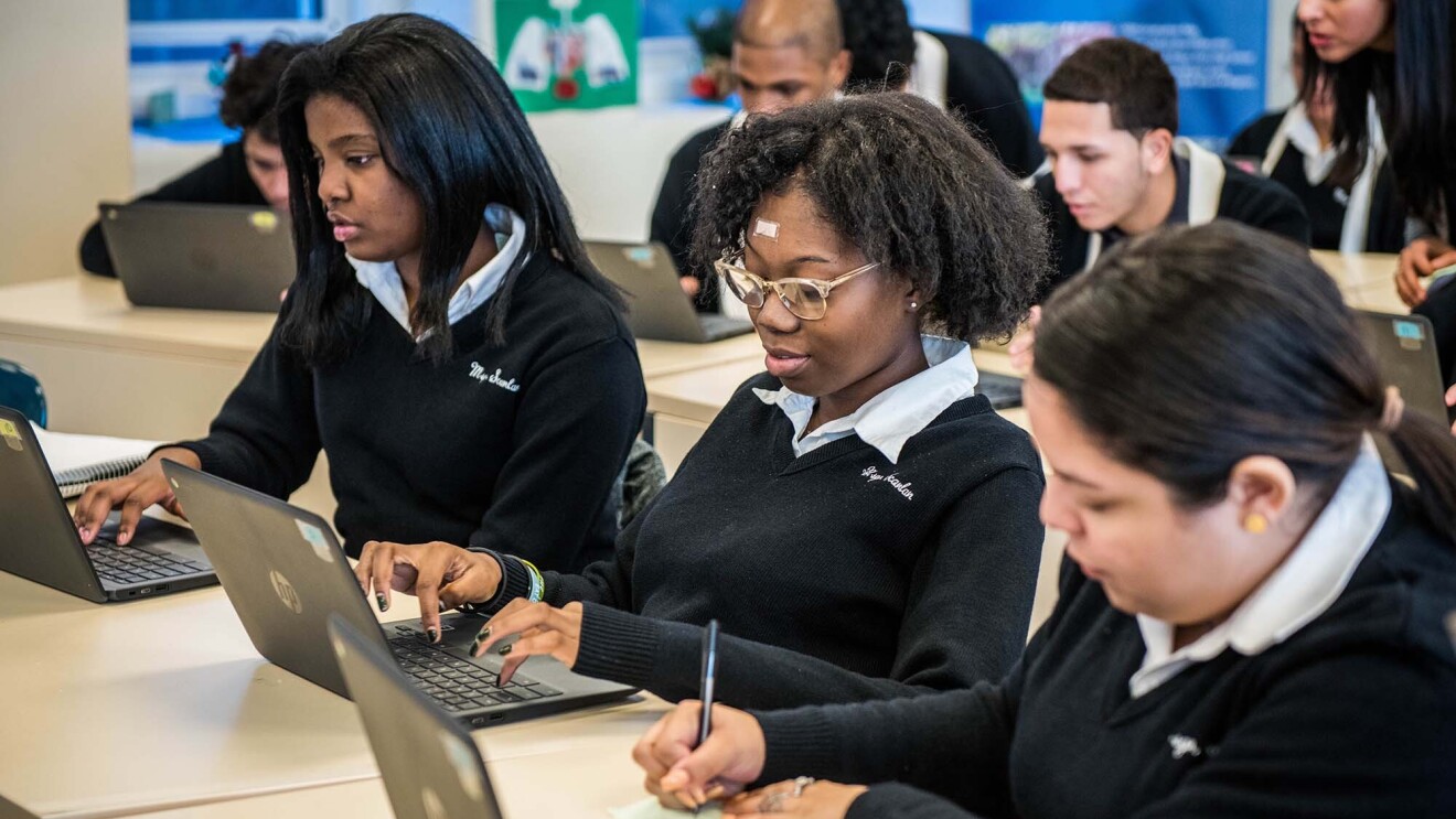 Students at Monsignor Scanlan High School working on laptop computers as they learn about computer science.