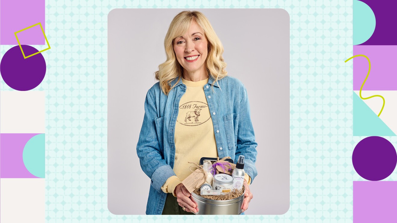 Woman holding gift basket with farm products, wearing denim shirt and 1818 Farms t-shirt