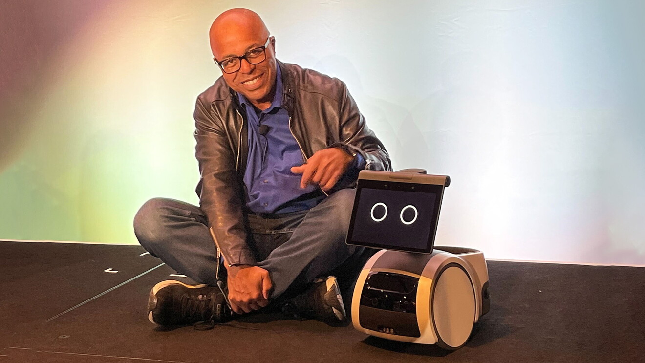 An image of Ken Washington with an Astro home robot.