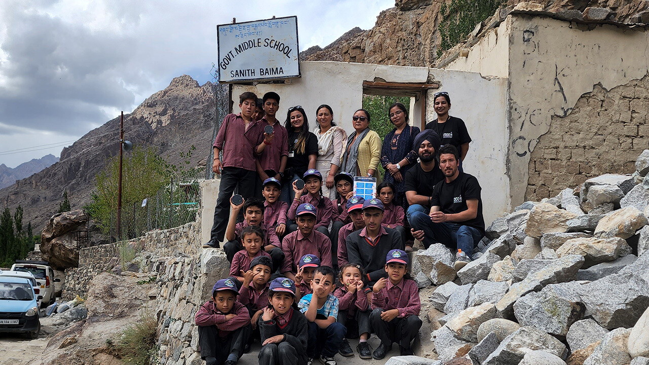 A group picture of the teachers, students and Alexa volunteers outside School in Sanith village