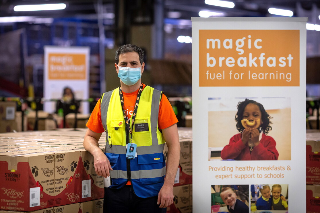 Amazon employee stood next to a Magic breakfast sign and cereal boxes