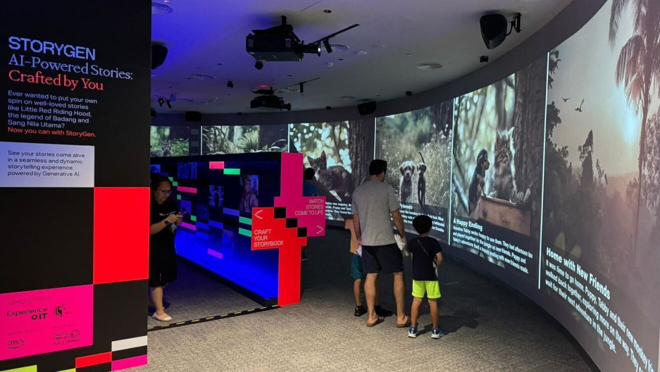 A man and two children experiencing StoryGen at the Central Public Library in Singapore.
