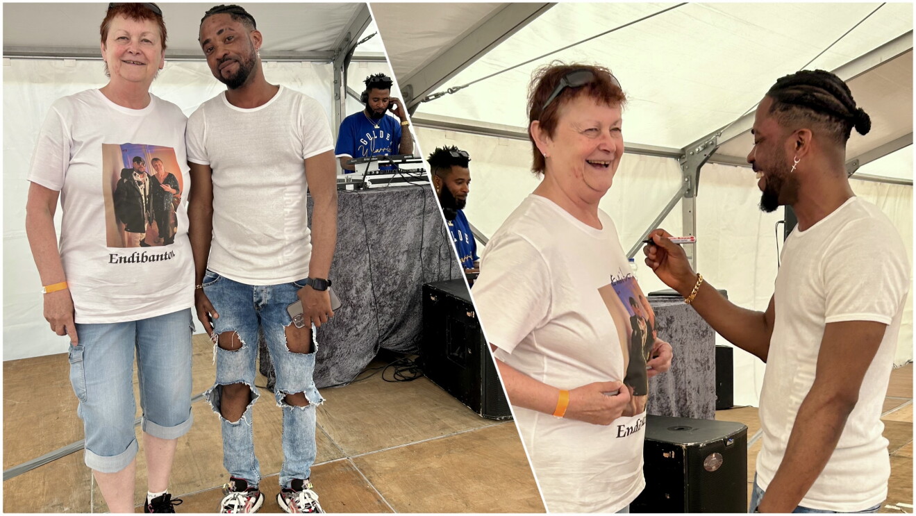 David, Amazon Versandmitarbeiter in Graben, in Cut-Out-Jeans und weißem T-Shrit neben Petra, die ein Fan-Shirt mit Aufschrift "Endibanton" trägt.